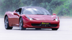 a Ferrari 457 driving around a race track for 6th Gear Experience